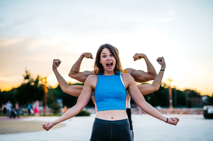 Three people in a row in various stages of making a muscle with their arms.