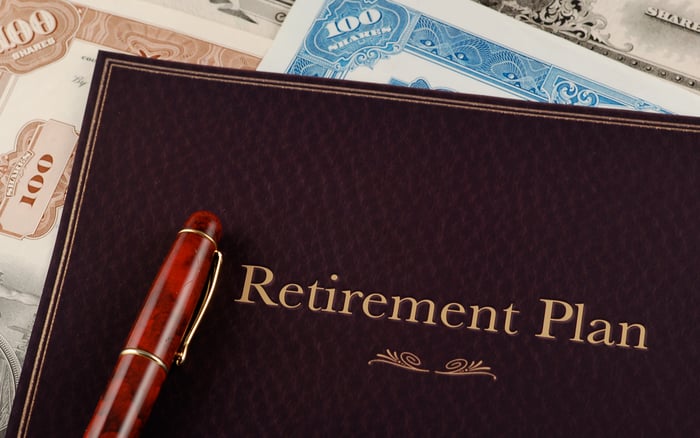 A folio that says Retirement Plan on top of some stock certificates.