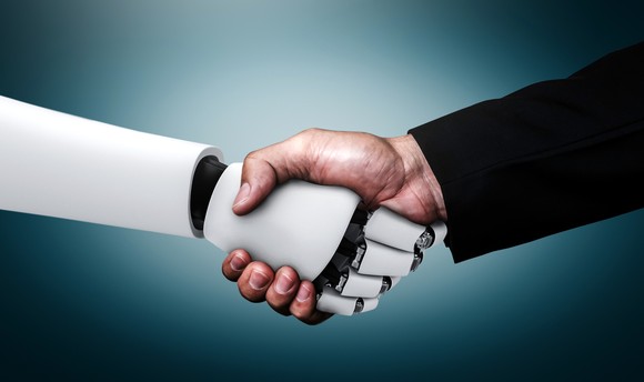 A human shaking hands with a robot.