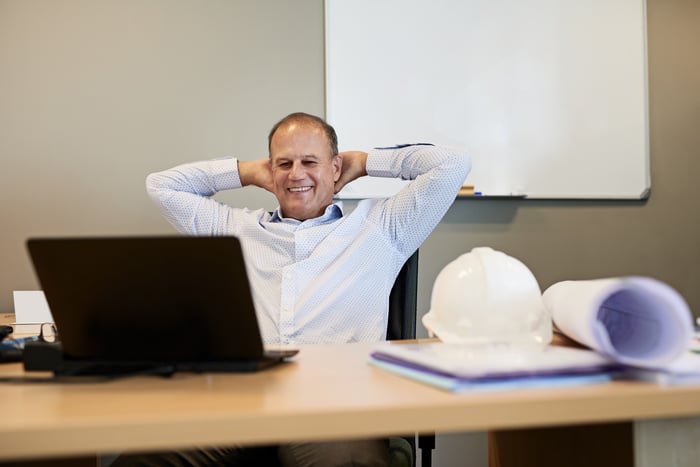 Smiling person on laptop.
