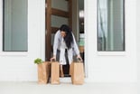 person getting groceries from front porch