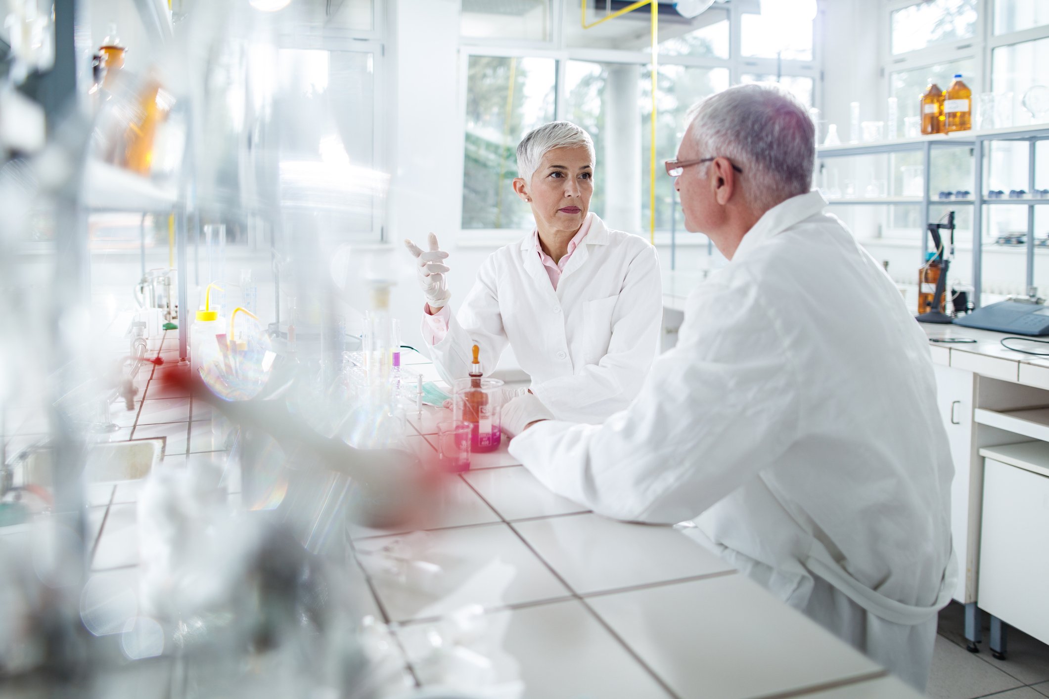 scientists talking about antiviral drug in laboratory