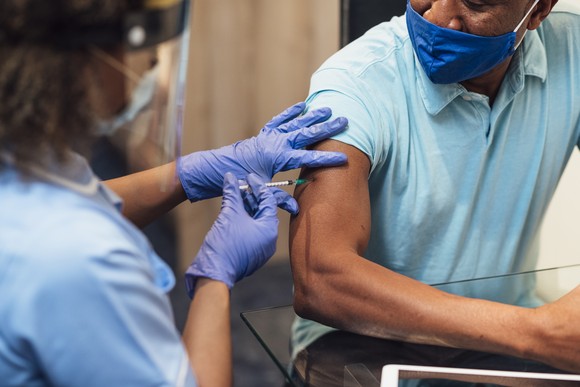 A doctor providing a vaccine to a patient.