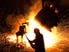 22_02_07 Steel Mill with sparks flying and person in the foreground _GettyImages-177541735