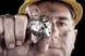 22_01_21 A person with a mining helmet on holding a silver nugget _GettyImages-134059508