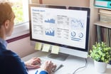 analyst analyzing stock charts on a computer screen