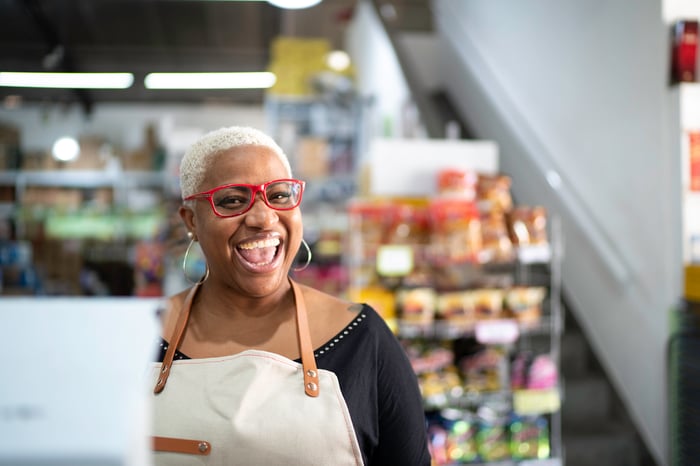 A smiling person in an apron.