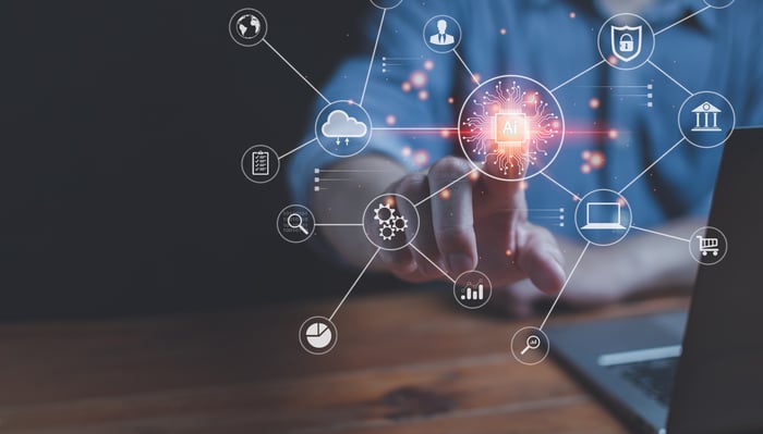 Person pressing virtual AI button surrounded by various technology icons.