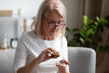 retired woman taking medication health pills pharmacy