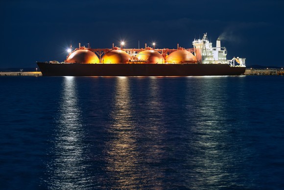 Floating LNG tanks on a ship at night.
