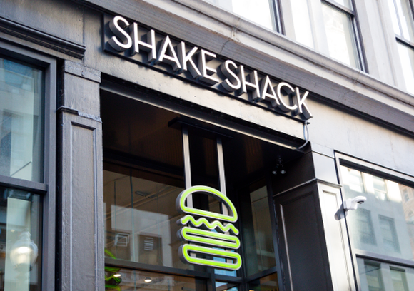 A Shake Shack sign on a restaurant door