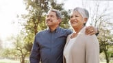 two people standing outside and smiling