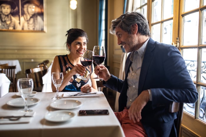 A couple toasting at a restaurant.