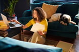 person sitting on the floor looking at a laptop