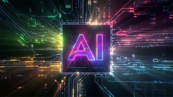 Fluorescent letters AI centered above a multicolored virtual circuit board.