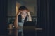 Concerned young person with head in hands gazing at a screen