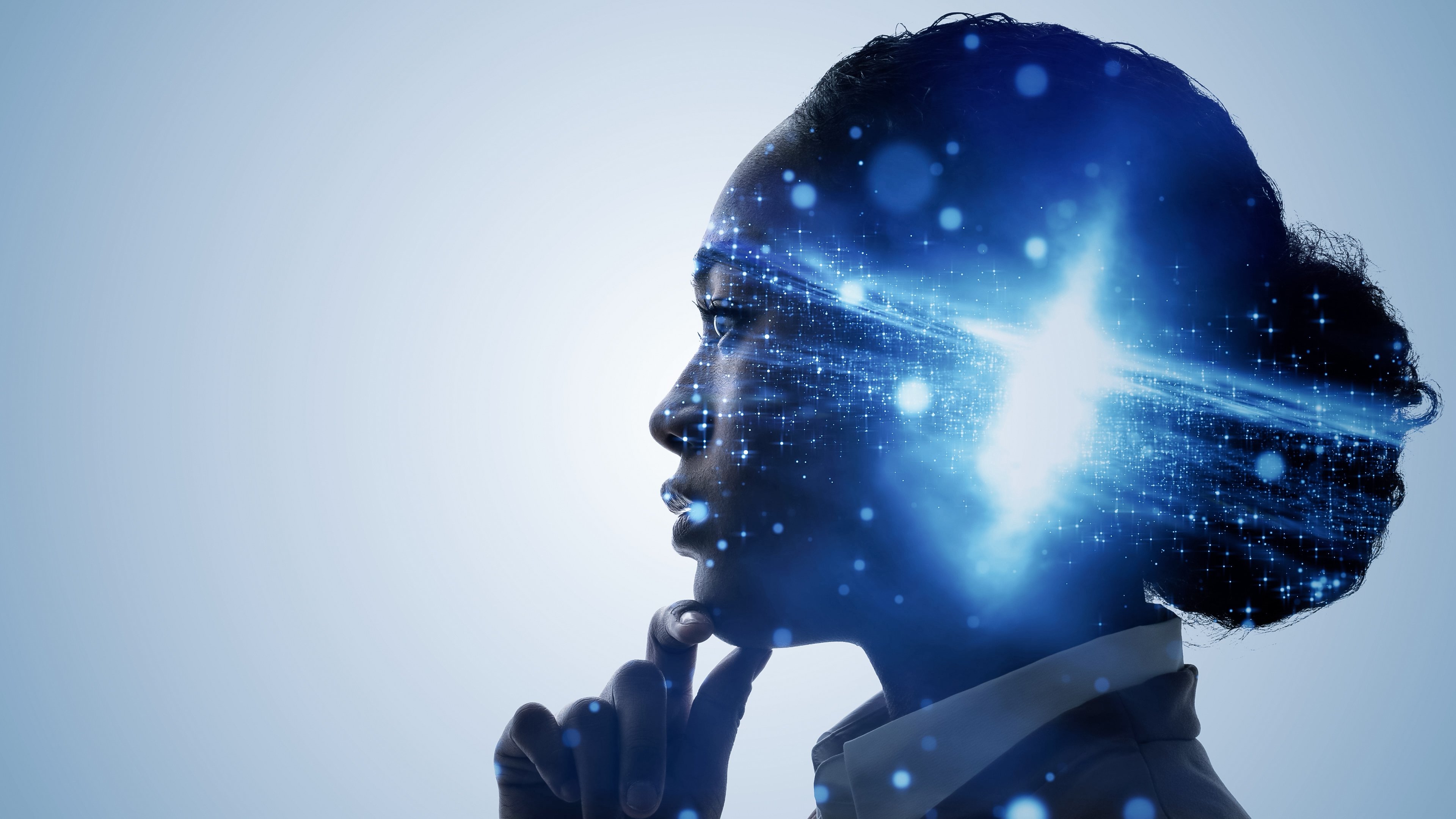 A side profile of a person in deep though, with a digital brain rendering overlay