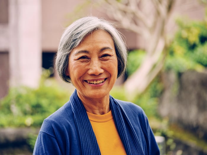 A person outdoors, smiling.