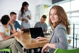young businesswoman with laptop in meeting smiling