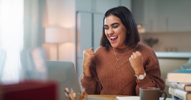 happy person at laptop success winning fists up victory yes