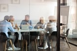 A group of people gathered around a table in an office