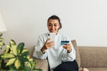 person on phone with credit card