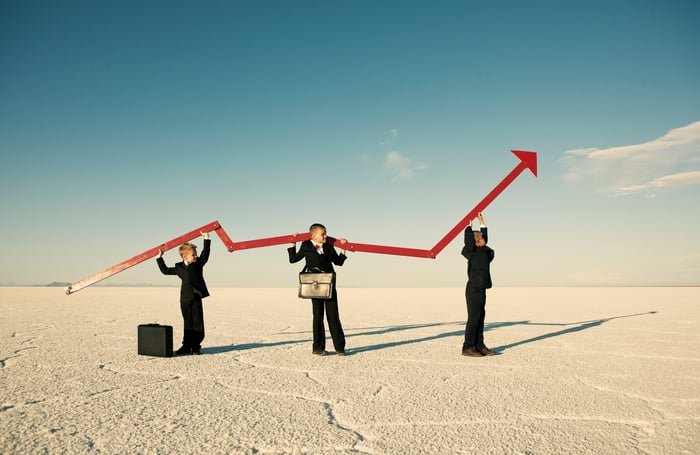 Three people holding arrow image