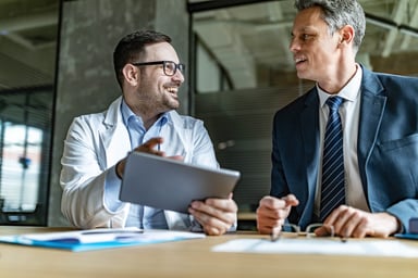 doctor and businessman working on digital tablet in the office