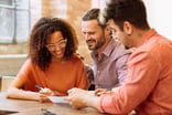 Smiling_couple_working_with_a_financial_consultant