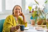 person sitting at a desk and smiling