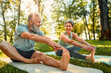 2 people doing yoga outside