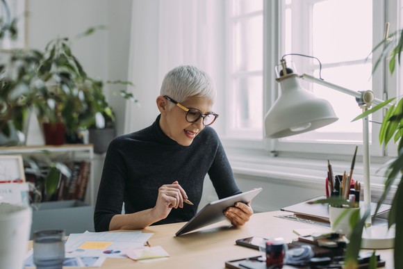 A seated person using a tablet.