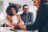Happy_couple_discussing_with_a_financial_advisor_in_a_office_meeting