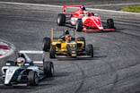 3 race cars circling a track.