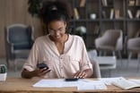 young person sitting at a desk looking at documents