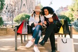 2 people with shopping bags and cellphones