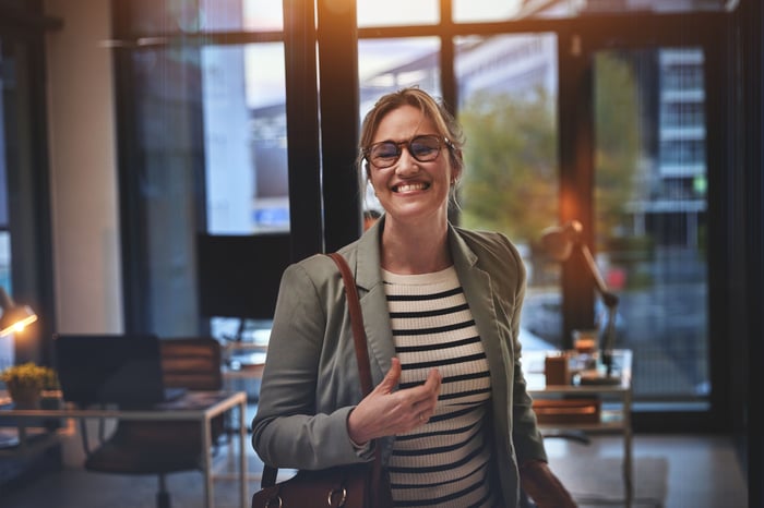 A smiling person standing up.