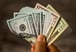 Man holding cash - dividends