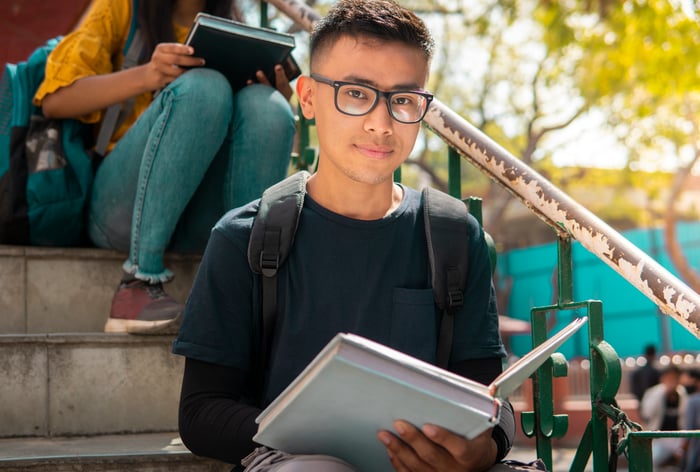 Student holding books.