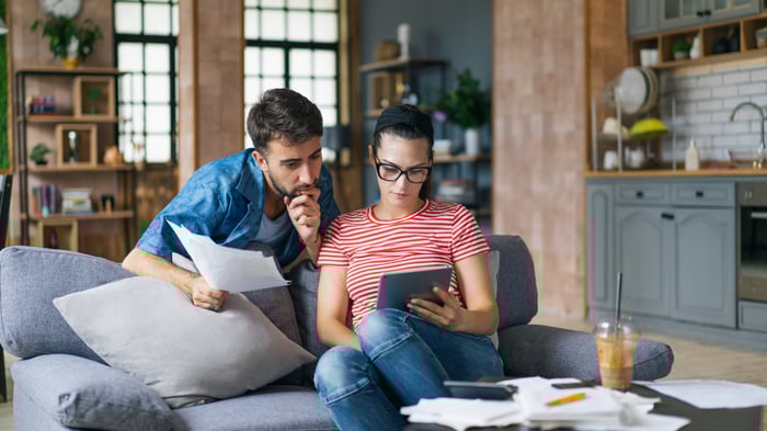 Two people checking a tablet computer.