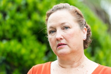 Getty - person looking concerned thoughtful worried green background