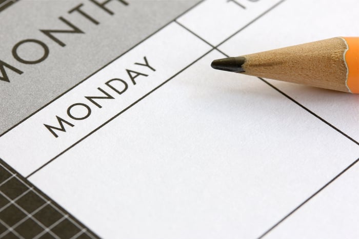 A pencil sitting on top of a calendar.