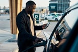 person charging EV electric vehicle charge station