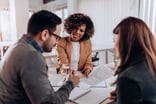 three investors meet with paperwork