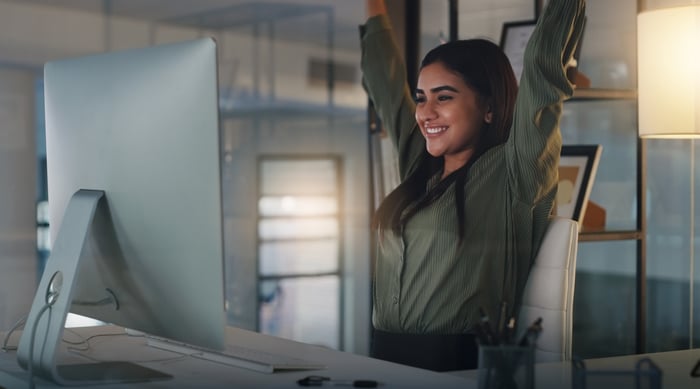 Someone celebrating what she's seeing on a monitor.