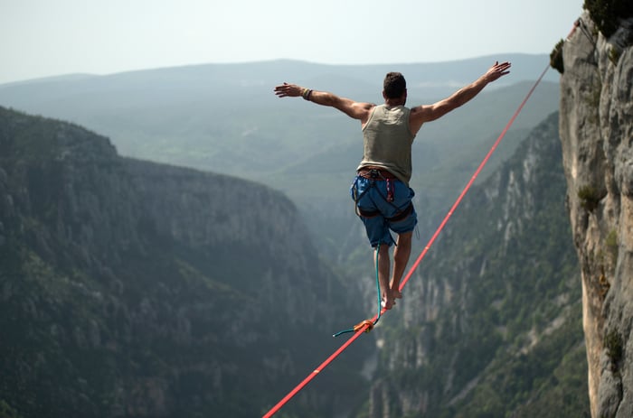 A person walking on a tightrope.
