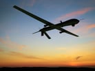 Predator drone flying at dawn.