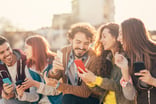 Friends_Looking_at_Mobile_Phones-GettyImages-833004468