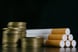 24_04_11 A pile of coins next to a bunch of cigarettes _MF DLOAD GettyImages-1352663466-1201x800-5b2df79