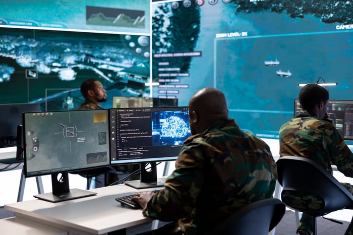 Military personnel using software at work.